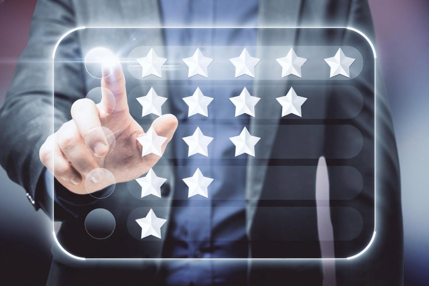 Businessman tapping a star rating on a touchscreen guest feedback system